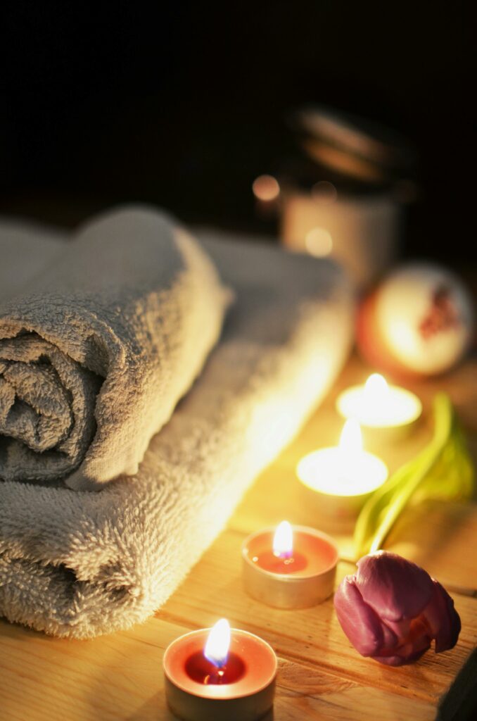 love-romantic-bath-candlelight-3188 Relaxing spa atmosphere with candles, towels, and a tulip, perfect for wellness and self-care.