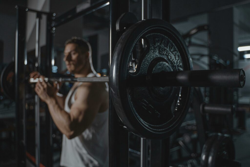 Homme s'apprêtant à soulever des haltères sur une station de musculation.