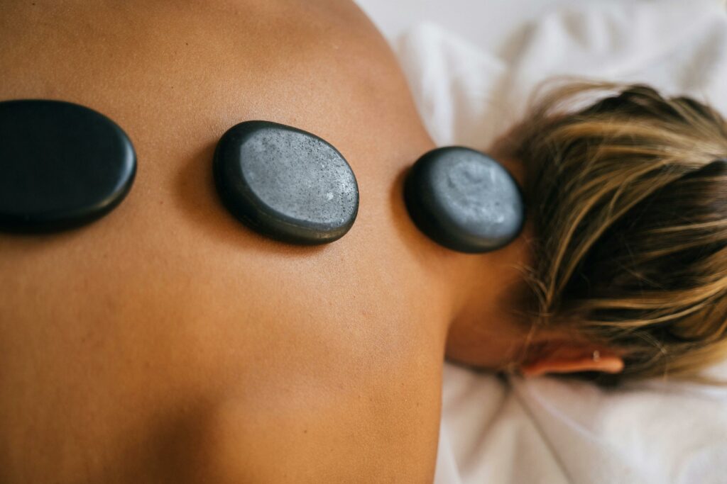 pexels-photo-6560281-6560281 Peaceful spa setting with hot stone therapy promoting relaxation and relief.
