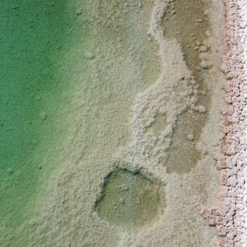 Aerial shot of salt formations along the shoreline of the Dead Sea in South District, Israel.